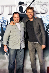 Hayden Christensen and Director Nick Powell on stage in front of new movie poster for Outcast at press launch in Beijing.